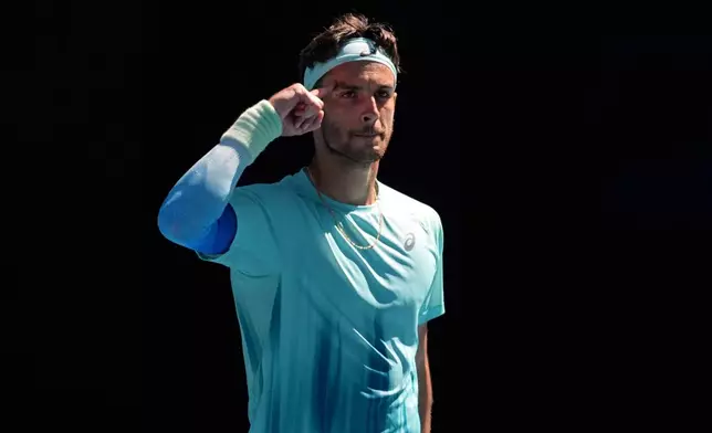 Lorenzo Musetti of Italy reacts after defeating Taylor Fritz of the U.S. during their fourth round match at the Australian Open tennis championship in Melbourne, Australia, Monday, Jan. 26, 2026. (AP Photo/Asanka Brendon Ratnayake)