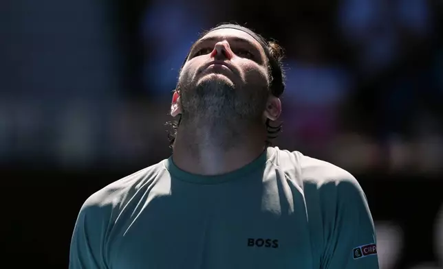 Taylor Fritz of the U.S. reacts as he plays against Lorenzo Musetti of Italy during their fourth round match at the Australian Open tennis championship in Melbourne, Australia, Monday, Jan. 26, 2026. (AP Photo/Asanka Brendon Ratnayake)