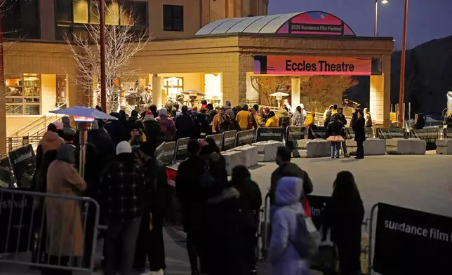 Audience members line up outside the Eccles Theatre during the Sundance Film Festival on Friday, Jan. 23, 2026, in Park City, Utah. (Photo by Charles Sykes/Invision/AP)