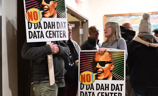 People opposed to a data center proposal at the former Pennhurst state hospital grounds talk during a break in an East Vincent Township supervisors meeting, Dec. 17, 2025, in Spring City, Pa. (AP Photo/Marc Levy)