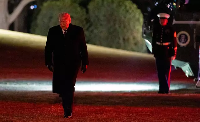 President Donald Trump walks from Marine One after arriving on the South Lawn of the White House, Thursday, Jan. 22, 2026, in Washington. (AP Photo/Alex Brandon)