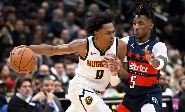 Denver Nuggets guard Peyton Watson (8) drive to the basket against Washington Wizards guard Jamir Watkins during the second half of an NBA basketball game, Thursday, Jan. 22, 2026, in Washington. (AP Photo/John McDonnell)