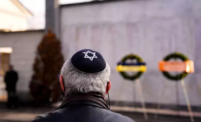 A Jewish man attends a ceremony commemorating the extermination of the Jewish people and their deportation to Nazi concentration camps on Holocaust Remembrance Day, at the Monumental Cemetery, in Turin, Italy, Tuesday, Jan. 27, 2026. (Fabio Ferrari/LaPresse via AP)