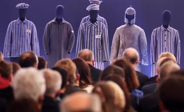 People attend a ceremony marking the 81th anniversary of the camp's liberation in the Auschwitz Nazi death camp museum in Oswiecim, Poland, Tuesday, Jan. 27, 2026. (AP Photo/Beata Zawrzel)