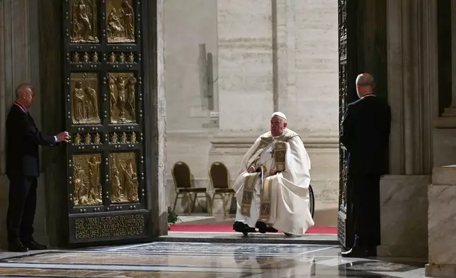 FILE - Pope Francis opens the Holy Door of St Peter's Basilica to mark the start of the Catholic Jubilee Year, at the Vatican, Dec. 24, 2024. (Alberto Pizzoli/Pool Photo via AP, file)