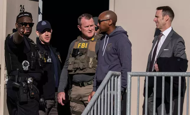 FBI agents are seen at the Fulton County Election Hub and Operation Center, Wednesday, Jan. 28, 2026, in Union City, Ga, near Atlanta. (AP Photo/Mike Stewart)
