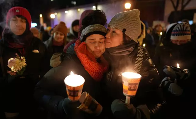 Attendees gather during a vigil where Alex Pretti was shot and killed by federal immigration enforcement in Minneapolis, on Wednesday, Jan. 28, 2026. (AP Photo/Adam Gray)