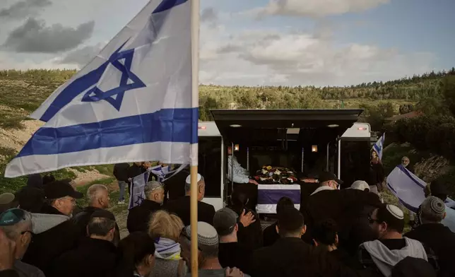 Mourners follow a vehicle carrying the coffin of Ran Gvili, the last Israeli hostage whose remains were recovered from the Gaza Strip, during his funeral in Meitar, Israel, Wednesday, Jan. 28, 2026. (AP Photo/Leo Correa)