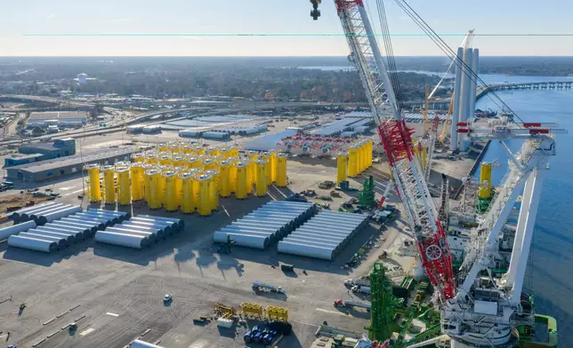 FILE - Wind turbine bases, generators and blades sit along with support ships at The Portsmouth Marine terminal that is the staging area for Dominion Energy Virginia, which is developing Coastal Virginia Offshore Wind, Dec. 22, 2025, in Portsmouth, Va. (AP Photo/Steve Helber, File)