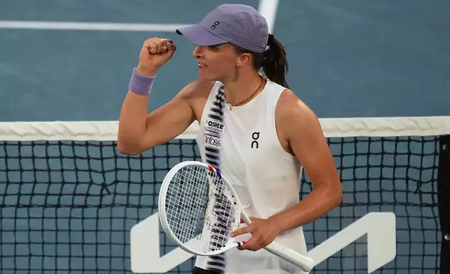 Iga Swiatek of Poland celebrates after defeating Maddison Inglis of Australia in their fourth round match at the Australian Open tennis championship in Melbourne, Australia, Monday, Jan. 26, 2026. (AP Photo/Mark Baker)