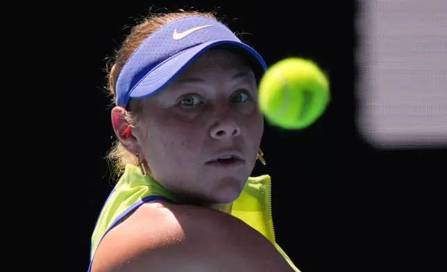Amanda Anisimova of the U.S. plays a backhand return to Wang Xinyu of China during their fourth round match at the Australian Open tennis championship in Melbourne, Australia, Monday, Jan. 26, 2026. (AP Photo/Aaron Favila)