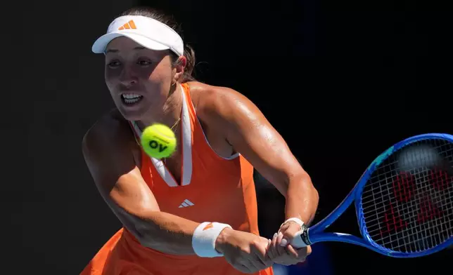 Jessica Pegula of the U.S. plays a backhand return to her compatriot Madison Keys during their fourth round match at the Australian Open tennis championship in Melbourne, Australia, Monday, Jan. 26, 2026. (AP Photo/Mark Baker)