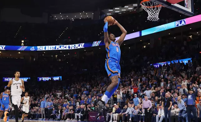 Oklahoma City Thunder guard Jalen Williams (8) goes up for a dunk in front of San Antonio Spurs forward Victor Wembanyama (1) during the second half of an NBA basketball game, Tuesday, Jan. 13, 2026, in Oklahoma City. (AP Photo/Nate Billings)