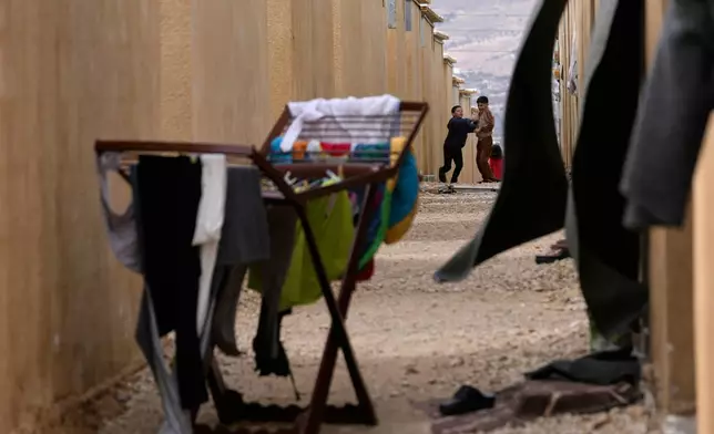 Syrian Shiite boys play at the Imam Ali Housing Compound, where hundreds of mostly Lebanese and Syrian Shiite Muslims displaced from Syria reside, in Hermel, northeast Lebanon, Friday, Jan. 30, 2026. (AP Photo/Hussein Malla)