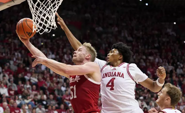 Nebraska forward Rienk Mast (51) shoots under the defense of Indiana forward Sam Alexis (4) during the first half of an NCAA college basketball game in Bloomington, Ind., Saturday, Jan. 10, 2026. (AP Photo/AJ Mast)