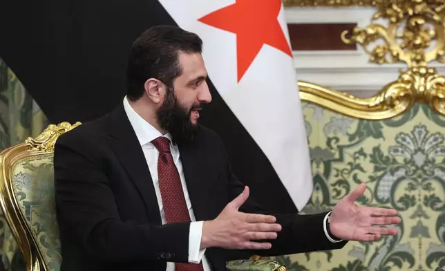Syrian interim President Ahmad al-Sharaa gestures while speaking to Russian President Vladimir Putin during their meeting at the Grand Kremlin Palace in Moscow, on Wednesday, Jan. 28, 2026. (Maxim Shipenkov/Pool Photo via AP)