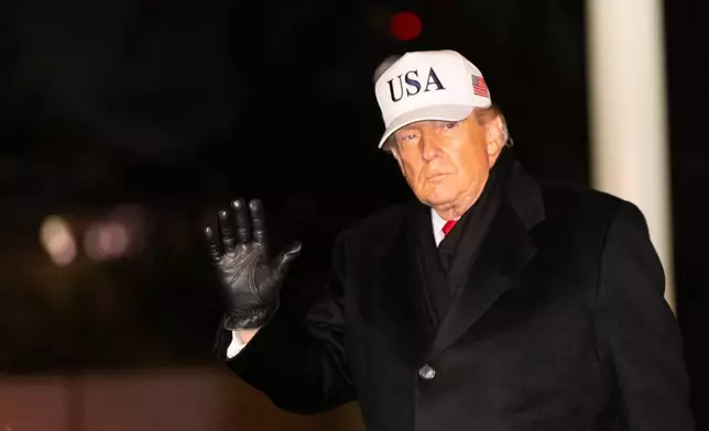 President Donald Trump waves as he walks from Marine One after arriving on the South Lawn of the White House, Tuesday, Jan. 27, 2026, in Washington. (AP Photo/Alex Brandon)