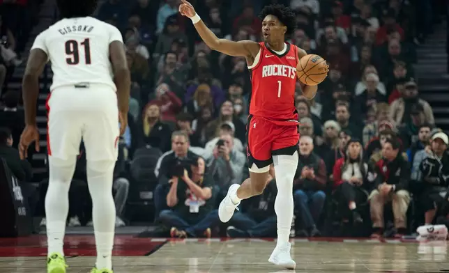 Houston Rockets forward Amen Thompson brings the ball up court against the Portland Trail Blazers during the first half of an NBA basketball game in Portland, Ore., Wednesday, Jan. 7, 2026. (AP Photo/Craig Mitchelldyer)