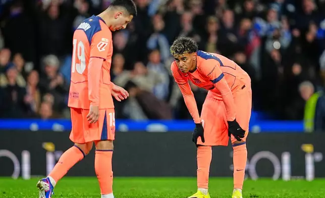 Barcelona's Roony Bardghji, left, and Barcelona's Lamine Yamal react during the Spanish La Liga soccer match between Real Sociedad and Barcelona in San Sebastian, Spain, Sunday, Jan. 18, 2026. (AP Photo/Miguel Oses)