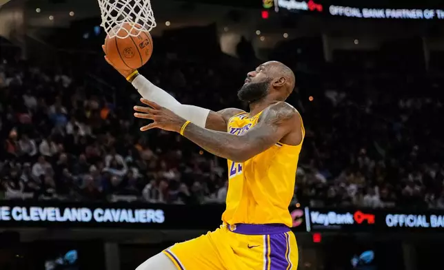 Los Angeles Lakers forward LeBron James goes to the basket in the second half of an NBA basketball game against the Cleveland Cavaliers in Cleveland, Wednesday, Jan. 28, 2026. (AP Photo/Sue Ogrocki)