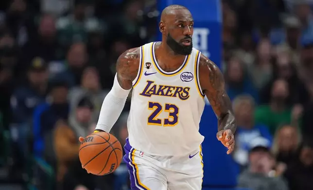 Los Angeles Lakers forward LeBron James dribbles the ball up court against the Dallas Mavericks during the first half of an NBA basketball game Saturday, Jan. 24, 2026, in Dallas. (AP Photo/Julio Cortez)