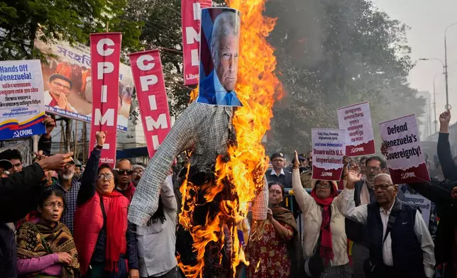 Activists of Communist Party of India (Marxist-Leninist) Liberation burn an effigy of Donald Trump during a protest against a U.S. military operation that removed Venezuelan leader Nicolas Maduro from the country, near the U.S. Consulate, in Kolkata, India, Monday, Jan. 5, 2026. (AP Photo/Bikas Das)