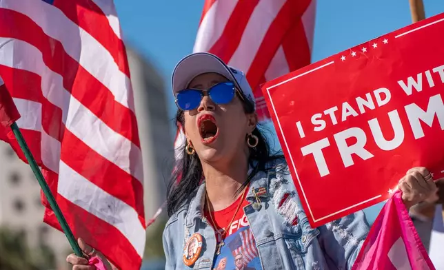 Maribel Gonzalez celebrates outside Versailles Cuban Cuisine after President Donald Trump announced President Nicolás Maduro had been captured and flown out of Venezuela, in Miami, Saturday, Jan. 3, 2026. (AP Photo/Jen Golbeck)