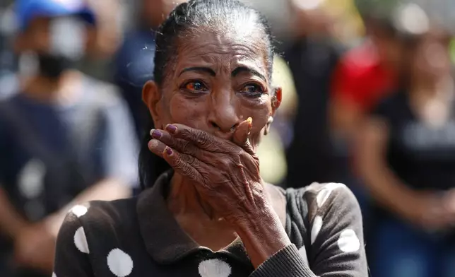 A woman cries during a rally of supporters of Venezuelan President Nicolás Maduro in Caracas, Venezuela, Saturday, Jan. 3, 2026, after U.S. President Donald Trump announced Maduro had been captured and flown out of the country. (AP Photo/Cristian Hernandez)