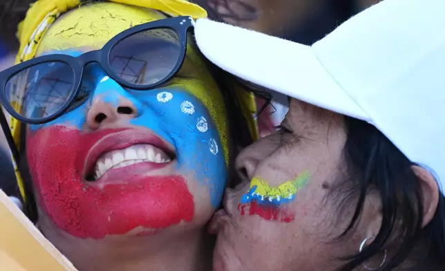 People celebrate at the Obelisk in Buenos Aires, Argentina, Saturday, Jan. 3, 2026, after U.S. President Donald Trump announced that President Nicolas Maduro had been captured and flown out of Venezuela. (AP Photo/Natacha Pisarenko)