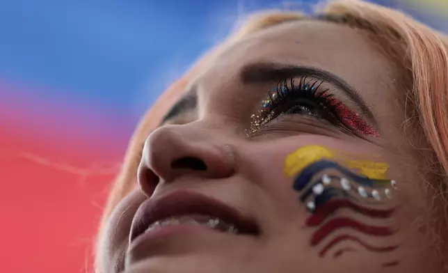 A Venezuelan celebrates in Bogotá, Colombia, Saturday, Jan. 3, 2026, after U.S. President Donald Trump announced that U.S. forces had captured Venezuelan President Nicolás Maduro. (AP Photo/Jose Vargas)