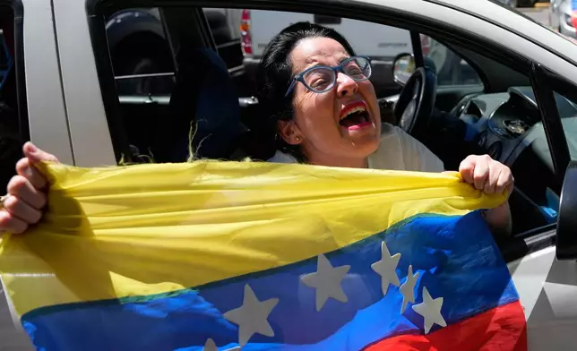 Venezuelans celebrate in Quito, Ecuador, Saturday, Jan. 3, 2026, after U.S. President Donald Trump announced the capture of Venezuelan President Nicolás Maduro. (AP Photo/Carlos Noriega)