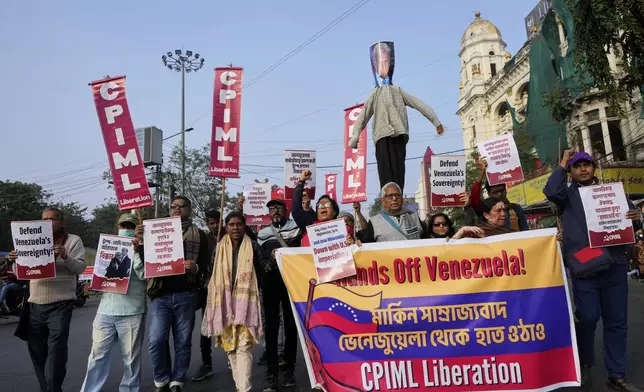 Activists of Communist Party of India (Marxist-Leninist) Liberation join in a rally with an effigy of Donald Trump during a protest against a U.S. military operation in Venezuela, near the U.S. Consulate, in Kolkata, India, Monday, Jan. 5, 2026. (AP Photo/Bikas Das)