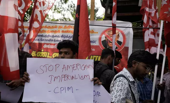 An activist of Communist Party of India (Marxist), CPI-M, hold placard during a protest against a U.S. military operation that removed Venezuelan leader Nicolas Maduro from the country, near the U.S. Embassy, in Chennai, India, Monday, Jan. 5, 2026. (AP Photo/Mahesh Kumar A.)