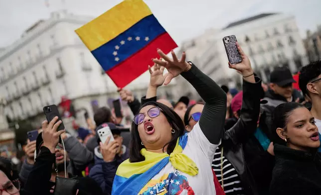 Venezuelan Wiliana Flores celebrates in Madrid after U.S. President Donald Trump announced that Venezuelan President Nicolás Maduro had been captured and flown out of the country on Saturday, Jan. 3, 2026. (AP Photo/Bernat Armangue)