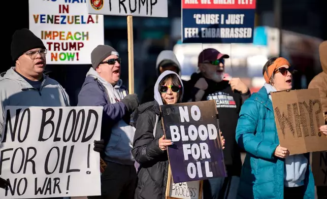 Protesters rally in front of the Ohio Statehouse in Columbus, Ohio, on Sunday, Jan. 4, 2026, after the U.S. captured Venezuelan President Nicolás Maduro and his wife in a military operation. (AP Photo/Jessica Phelps)
