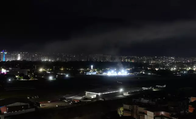 Smoke raises at La Carlota airport after explosions and low-flying aircraft were heard in Caracas, Venezuela, Saturday, Jan. 3, 2026. (AP Photo/Matias Delacroix)
