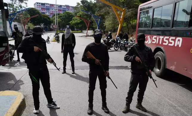 Pro-government armed civilians block streets in Caracas, Venezuela, Saturday, Jan. 3, 2026, after U.S. President Donald Trump announced that President Nicolás Maduro had been captured and flown out of the country. (AP Photo/Matias Delacroix)