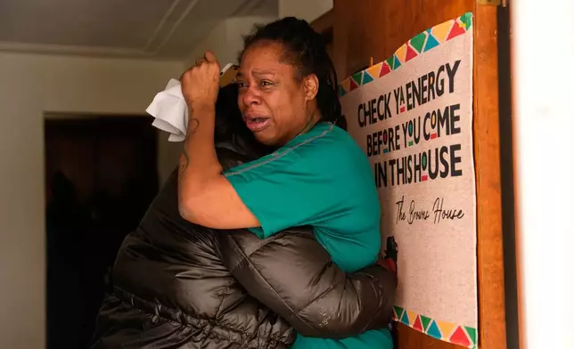 A family member reacts after federal immigration officers make an arrest Sunday, Jan. 11, 2026, in Minneapolis. (AP Photo/John Locher)