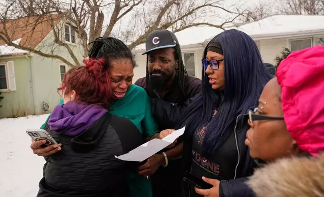 A family member reacts after federal immigration officers make an arrest Sunday, Jan. 11, 2026, in Minneapolis. (AP Photo/John Locher)