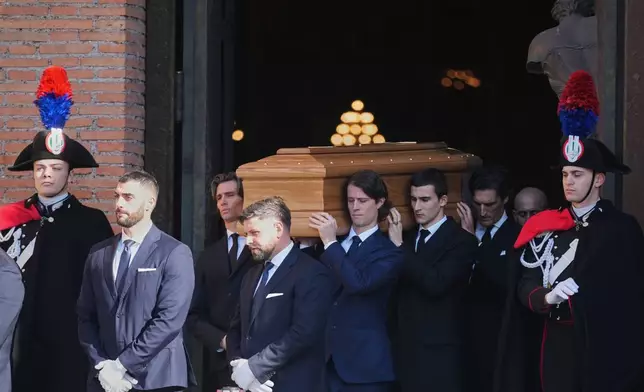 The casket of fashion designer Valentino Garavani leaves the St. Mary of Angels Basilica at the end of his funeral, in Rome, Friday, Jan. 23, 2026. (AP Photo/Andrew Medichini)