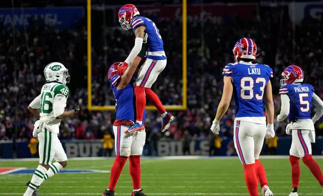 Buffalo Bills wide receiver Keon Coleman (0) is picked by guard O'Cyrus Torrence after Coleman caught a pass for a 2-point conversion against the New York Jets the second half of an NFL football game Sunday, Jan. 4, 2026, in Orchard Park, N.Y. (AP Photo/Seth Wenig)