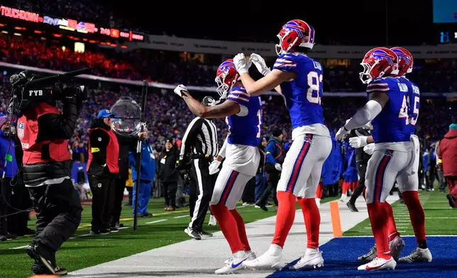 Buffalo Bills players celebrate after a touchdown in the second half of an NFL football game against the New York Jets Sunday, Jan. 4, 2026, in Orchard Park, N.Y. (AP Photo/Adrian Kraus)