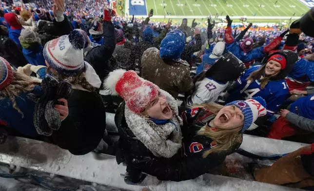 Fans celebrate and throw snow in the stands after an NFL football game between the Buffalo Bills and the New York Jets, Sunday, Jan. 4, 2026, in Orchard Park, N.Y. (AP Photo/Carolyn Kaster)