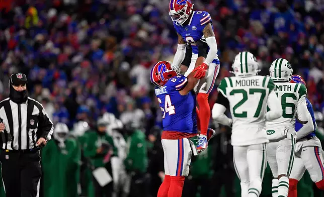 Buffalo Bills wide receiver Keon Coleman (0) is picked by guard O'Cyrus Torrence after Coleman caught a pass for a 2-point conversion against the New York Jets the second half of an NFL football game Sunday, Jan. 4, 2026, in Orchard Park, N.Y. (AP Photo/Adrian Kraus)