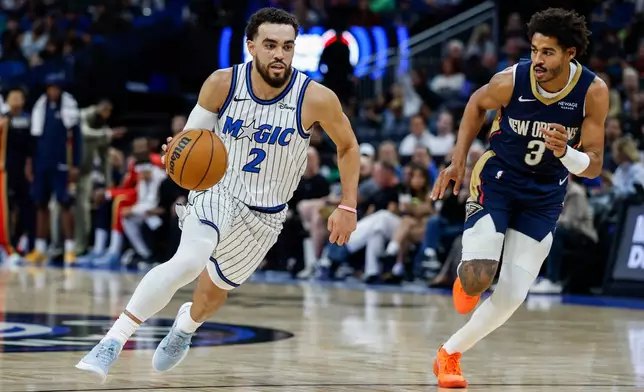 Orlando Magic guard Desmond Bane (3) drives down the court against New Orleans Pelicans guard Jordan Poole (3) during the first half of an NBA basketball game, Sunday, Jan. 11, 2026, in Orlando, Fla. (AP Photo/Kevin Kolczynski)