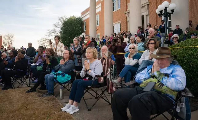 Supporters pray with Buddhist monks who are participating in the, "Walk For Peace," Thursday, Jan. 8, 2026, in Saluda, S.C. (AP Photo/Allison Joyce)