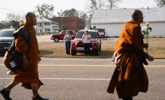 Supporters watch Buddhist monks who are participating in the, "Walk For Peace," Thursday, Jan. 8, 2026, in Saluda, S.C. (AP Photo/Allison Joyce)