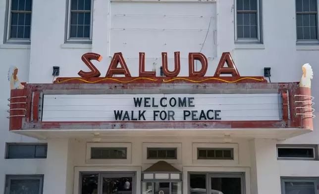 A sign is seen greeting the Buddhist monks who are participating in the, "Walk For Peace," Thursday, Jan. 8, 2026, in Saluda, S.C. (AP Photo/Allison Joyce)