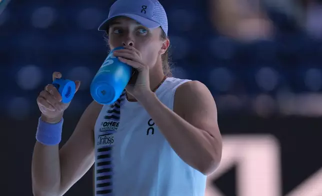 Iga Swiatek of Poland takes a drink during her quarterfinal match against Elena Rybakina of Kazakhstan at the Australian Open tennis championship in Melbourne, Australia, Wednesday, Jan. 28, 2026. (AP Photo/Dita Alangkara)