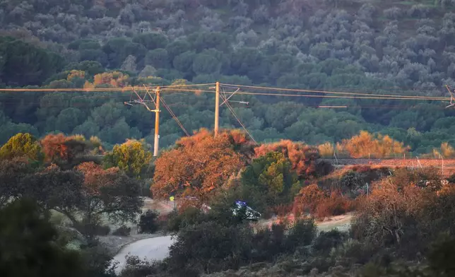 Police cars near the site of a high-speed train collision in Adamuz, near Córdoba, southern Spain, Monday, Jan. 19, 2026. (AP Photo/Manu Fernandez)